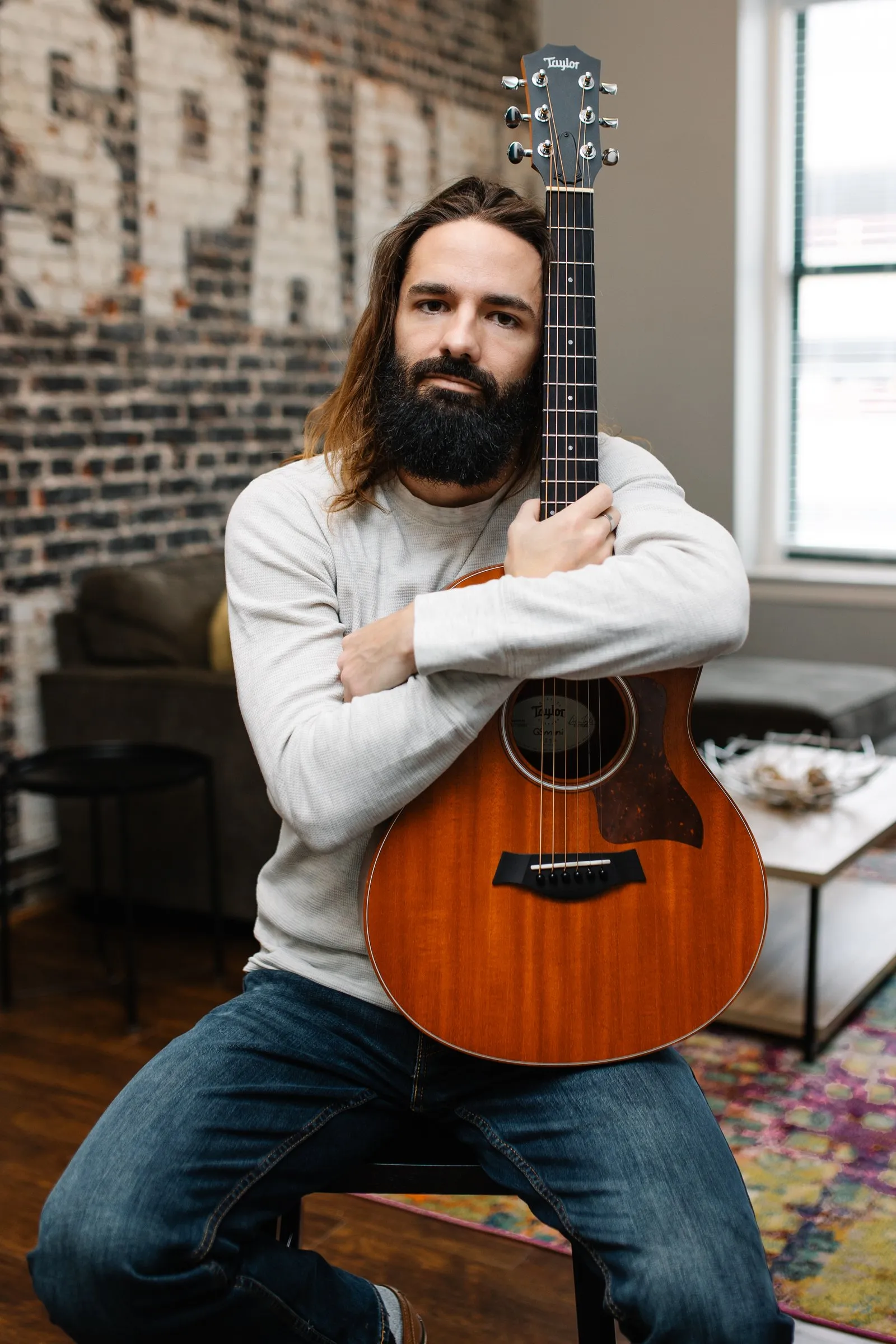 Borin holding an acoustic guitar